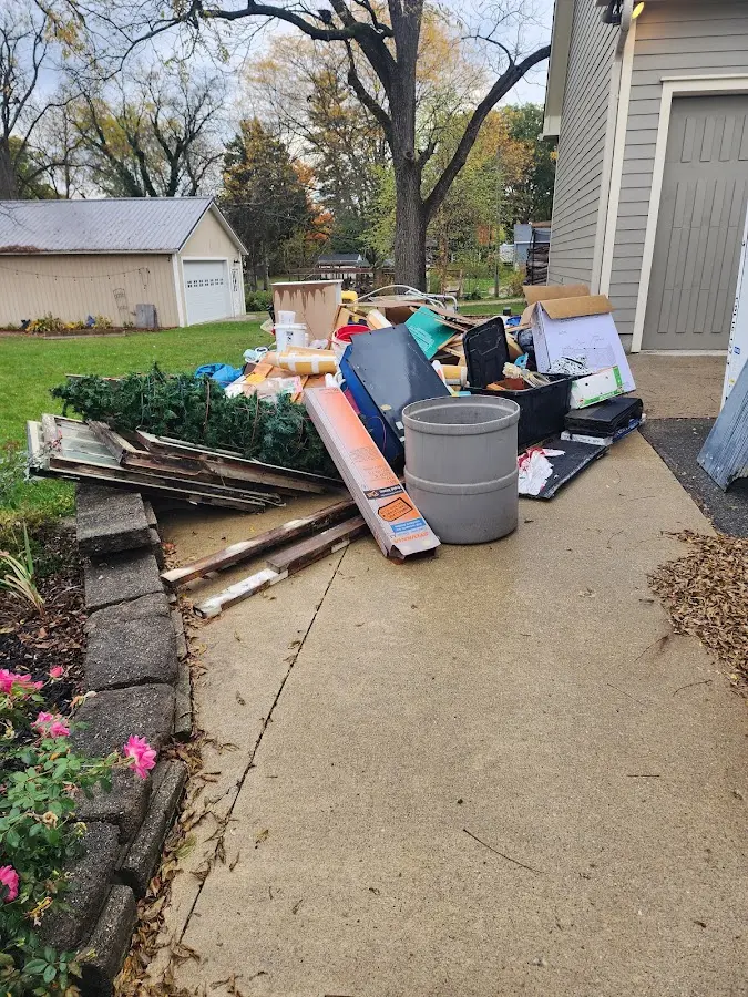 Dumpster being loaded with debris for 12 Yard Dumpster Rental in Carrollton